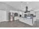 Modern kitchen with white cabinets, granite countertops, stainless steel appliances, and stylish backsplash at 5091 Plymouth Turtle Cir, St Cloud, FL 34772
