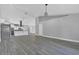 Open-concept living area with vaulted ceilings, gray tile flooring, and modern lighting at 5091 Plymouth Turtle Cir, St Cloud, FL 34772