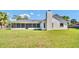 View of a well-kept backyard, screened in porch and chimney at 1458 Heather Way, Kissimmee, FL 34744