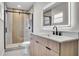 Bathroom featuring a glass shower, modern vanity, and sleek fixtures, providing both style and functionality at 1458 Heather Way, Kissimmee, FL 34744