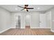 The primary bedroom features light hardwood floors and multiple entrances including to the bathroom at 1458 Heather Way, Kissimmee, FL 34744