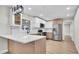 Modern kitchen with an island, stylish lighting, and stainless steel appliances at 1458 Heather Way, Kissimmee, FL 34744
