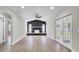Spacious living room with stone fireplace, wood-look floors, and bright natural light at 1458 Heather Way, Kissimmee, FL 34744