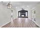 Open living room featuring a statement fireplace and stylish ceiling fan at 1458 Heather Way, Kissimmee, FL 34744