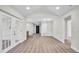 A spacious living room with wood floors features natural lighting and multiple points of entry at 1458 Heather Way, Kissimmee, FL 34744