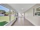 Large sunroom features tile flooring and multiple large windows overlooking yard at 1458 Heather Way, Kissimmee, FL 34744