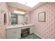 Bathroom featuring vanity, large mirror, and unique pink floral wallpaper for a touch of style at 180 Broadmoor Rd, Lake Mary, FL 32746