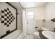 A bathroom showcasing unique black-and-white tile and a bathtub with shower at 180 Broadmoor Rd, Lake Mary, FL 32746