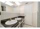 Bathroom featuring double sinks, ample counter space, and stylish black-and-white tile at 180 Broadmoor Rd, Lake Mary, FL 32746
