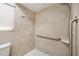 Modern shower with neutral tiles, grab bars, and a built-in soap dish for added convenience at 180 Broadmoor Rd, Lake Mary, FL 32746