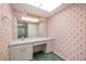 Bathroom featuring vanity, large mirror, and unique pink floral wallpaper for a touch of style at 180 Broadmoor Rd, Lake Mary, FL 32746
