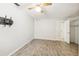 Bedroom with laminate flooring and wall mounted TV mount; next to closet and bathroom at 180 Broadmoor Rd, Lake Mary, FL 32746