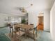 Dining area with a wooden table and six chairs under a decorative chandelier, adjacent to the living room at 180 Broadmoor Rd, Lake Mary, FL 32746