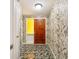 Home entryway featuring detailed wallpaper and a wooden front door with a small decorative yellow window at 180 Broadmoor Rd, Lake Mary, FL 32746