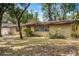 Ranch-style home featuring a brick facade, large front yard with mature trees, and lovely landscaping at 180 Broadmoor Rd, Lake Mary, FL 32746