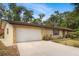 Charming single-story home with a two-car garage, brick exterior, and well-maintained landscaping at 180 Broadmoor Rd, Lake Mary, FL 32746