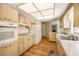 A well-lit kitchen with wood flooring, appliances and countertops, and ample cabinet space at 180 Broadmoor Rd, Lake Mary, FL 32746