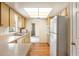 A kitchen with a microwave, range, and a stainless steel sink beneath a bright window at 180 Broadmoor Rd, Lake Mary, FL 32746
