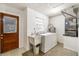 Functional laundry room with sink, washer, dryer, water heater and exterior access at 180 Broadmoor Rd, Lake Mary, FL 32746