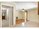 Open-concept living room features wood floors, ceiling fan, and entryway to hallway at 180 Broadmoor Rd, Lake Mary, FL 32746