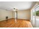 An empty living room with wood floors and sliding glass doors leading to the yard at 180 Broadmoor Rd, Lake Mary, FL 32746