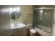Bathroom with vanity, mirror, and shower-tub combo with glass doors at 200 Saint Andrews Blvd # 2306, Winter Park, FL 32792