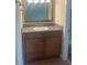 Bathroom vanity with granite countertops, sink, mirror, and wood cabinetry at 200 Saint Andrews Blvd # 2306, Winter Park, FL 32792