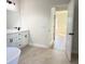 Bathroom with double sink vanity, white cabinets, black hardware, and stylish tile flooring at 2406 Sw 163Rd Pl, Ocala, FL 34473