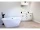 Bright bathroom with a modern freestanding tub, double sink vanity and stylish tile flooring at 2406 Sw 163Rd Pl, Ocala, FL 34473