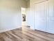 Bedroom view showcasing closet, wood-look flooring and fresh neutral paint at 2406 Sw 163Rd Pl, Ocala, FL 34473