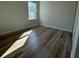 Bedroom view showcasing window, wood-look flooring and fresh neutral paint at 2406 Sw 163Rd Pl, Ocala, FL 34473