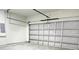 Spacious garage interior with a partially open door, offering ample storage or parking at 2406 Sw 163Rd Pl, Ocala, FL 34473