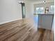 Open-concept floor plan featuring sleek wood floors and a kitchen island with modern black fixtures at 2406 Sw 163Rd Pl, Ocala, FL 34473