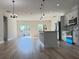 Open floor plan showcasing kitchen island, stainless steel appliances, and modern pendant lighting for an inviting living space at 2406 Sw 163Rd Pl, Ocala, FL 34473