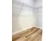 Spacious walk-in closet featuring built-in wire shelving and modern wood-look flooring at 2406 Sw 163Rd Pl, Ocala, FL 34473