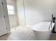 This bathroom features a soaking tub, walk-in shower, and neutral finishes at 2697 Sw 165St Rd, Ocala, FL 34473