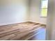 Bedroom features wood-look floors, base trim and a large window at 2697 Sw 165St Rd, Ocala, FL 34473