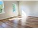 Bedroom showcasing hardwood floors, neutral walls, and natural light from two windows at 2697 Sw 165St Rd, Ocala, FL 34473