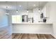 Modern kitchen featuring white cabinets, stainless steel appliances, and a spacious quartz countertop at 2697 Sw 165St Rd, Ocala, FL 34473