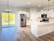Modern kitchen featuring white cabinets, stainless steel appliances, and a spacious quartz countertop at 2697 Sw 165St Rd, Ocala, FL 34473