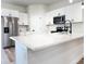 Modern kitchen featuring white cabinets, stainless steel appliances, and a spacious quartz countertop at 2697 Sw 165St Rd, Ocala, FL 34473