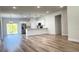 Open-concept living room with modern kitchen, stainless steel appliances, and hardwood floors at 2697 Sw 165St Rd, Ocala, FL 34473