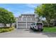 Two-story home with attached garage and deck situated in a landscaped front yard with a clear blue sky at 5125 Cypress Creek Dr # 2, Orlando, FL 32811