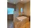 Bathroom with a soaking tub, walk-in shower with glass block accents, vanity with granite countertop at 708 Palenci Ct, Winter Springs, FL 32708