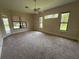 Light filled bedroom with plush carpeting, ceiling fan, and a large window overlooking the backyard at 708 Palenci Ct, Winter Springs, FL 32708