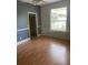 An empty bedroom with hardwood floors, a window, and a closet at 708 Palenci Ct, Winter Springs, FL 32708