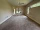 Neutral bedroom with plush carpeting, a ceiling fan, and large window for natural light at 708 Palenci Ct, Winter Springs, FL 32708