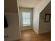 Bedroom featuring laminate flooring, a window with blinds, and an accent mirror at 708 Palenci Ct, Winter Springs, FL 32708
