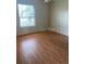 A simple bedroom with a window and hardwood floors at 708 Palenci Ct, Winter Springs, FL 32708