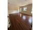 Large bedroom with hardwood floors, chair rail, and bright natural light from three windows at 708 Palenci Ct, Winter Springs, FL 32708